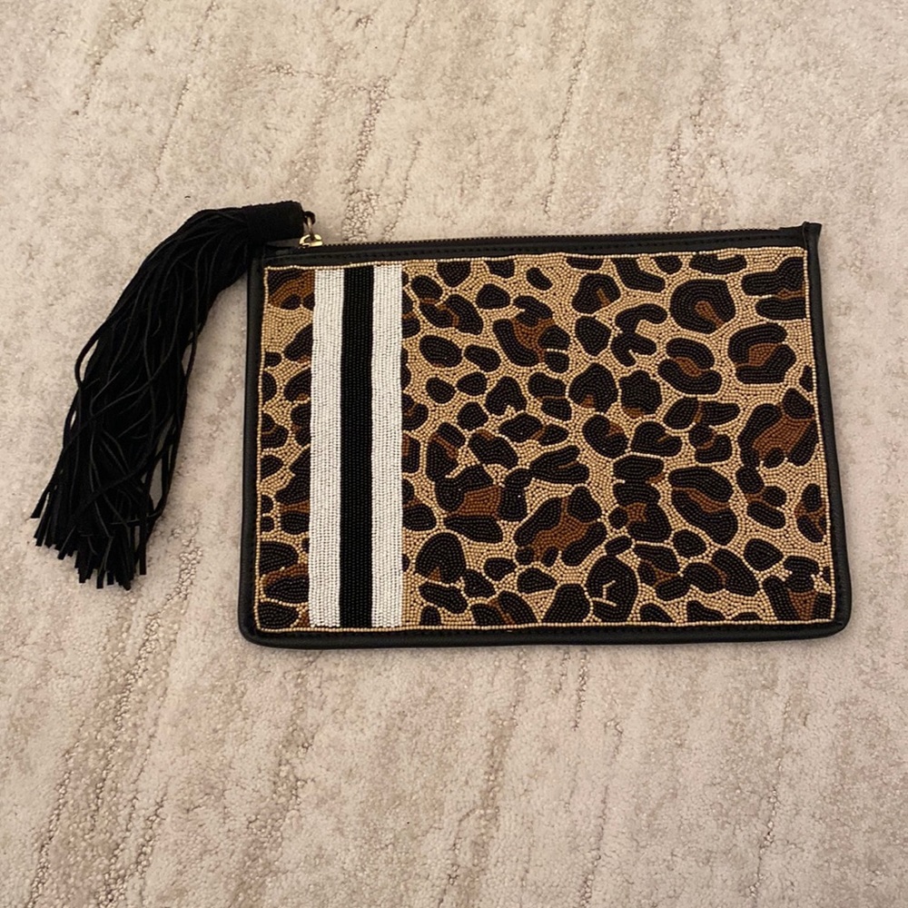 Brand new, never used, Sam Edelman clutch. Beaded front with suede tassel.